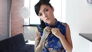 Breasts bursting from a Chinese dress